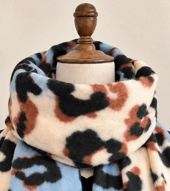 XXL multi shawl featuring bold leopard print in cream, light blue, brown, and black with fringe.