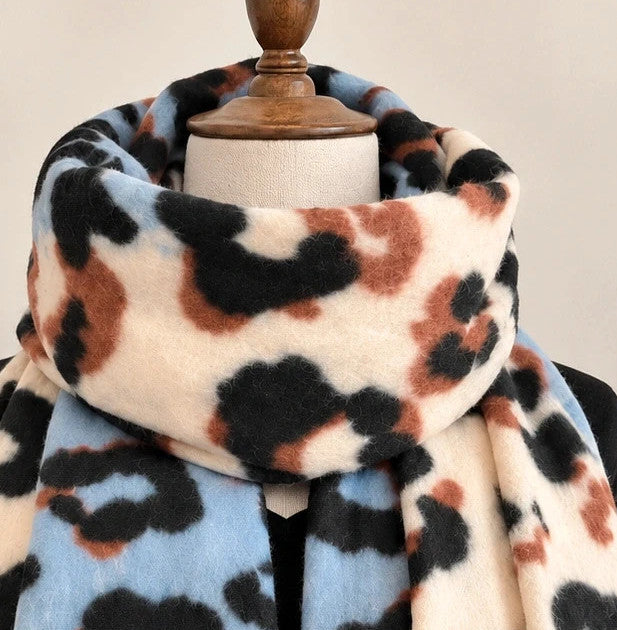 XXL multi shawl featuring bold leopard print in cream, light blue, brown, and black with fringe.