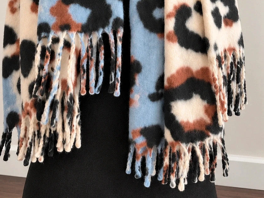 XXL multi shawl featuring bold leopard print in cream, light blue, brown, and black with fringe.