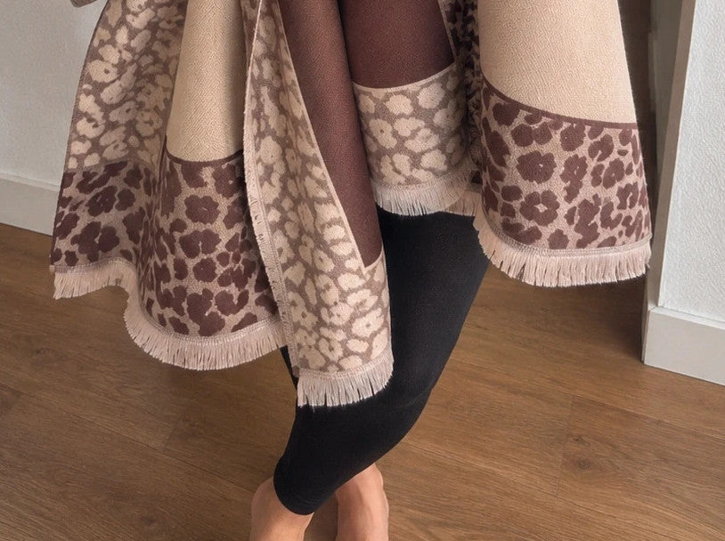 Beige scarf with brown leopard print edges and decorative fringes, reversible design.