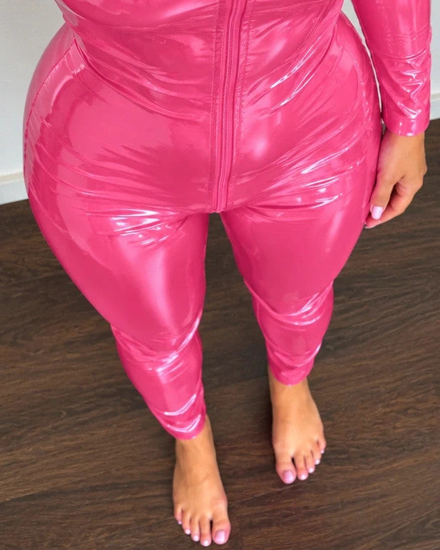 REI pink jumpsuit fitted design with long sleeves, front zipper, and stand collar.