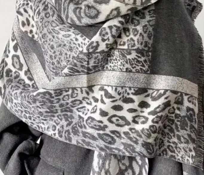 Creme reversible scarf grey and cream with leopard print and geometric patterns, fringed ends.