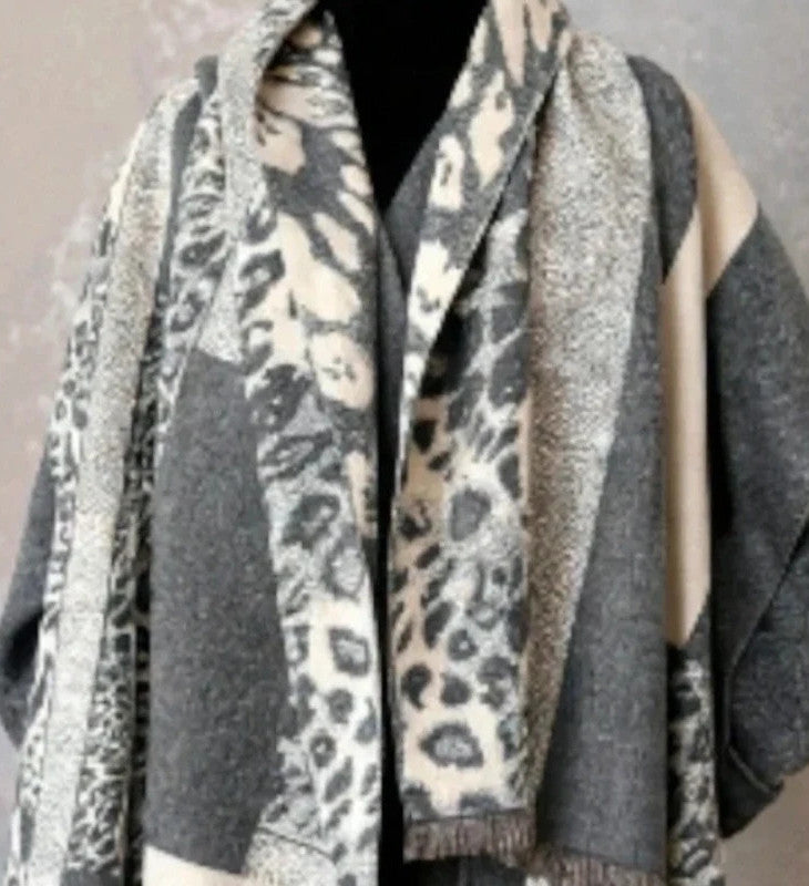 Creme reversible scarf grey and cream with leopard print and geometric patterns, fringed ends.