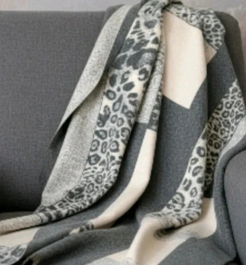Creme reversible scarf grey and cream with leopard print and geometric patterns, fringed ends.