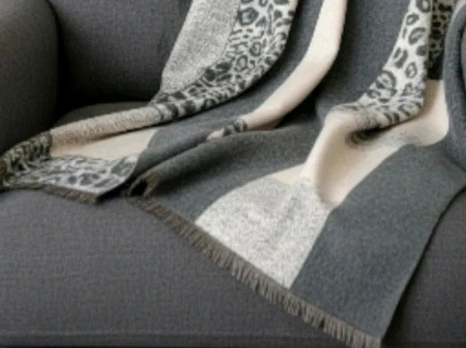 Creme reversible scarf grey and cream with leopard print and geometric patterns, fringed ends.