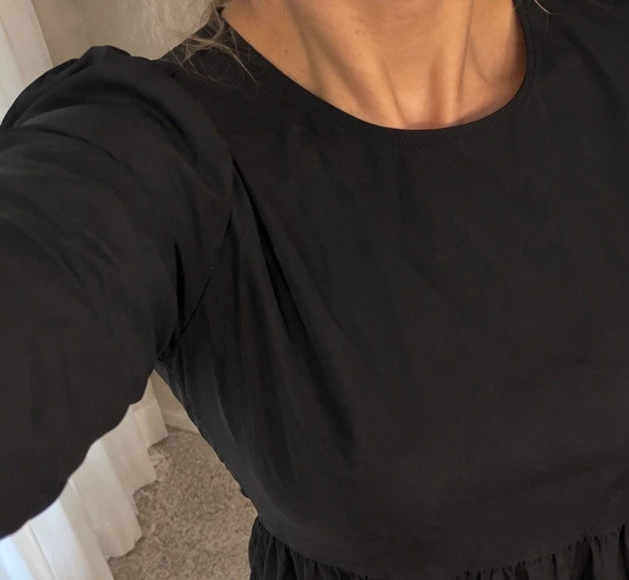 SheIn black oversized A-line dress with layered ruffle sleeves and asymmetrical hem.