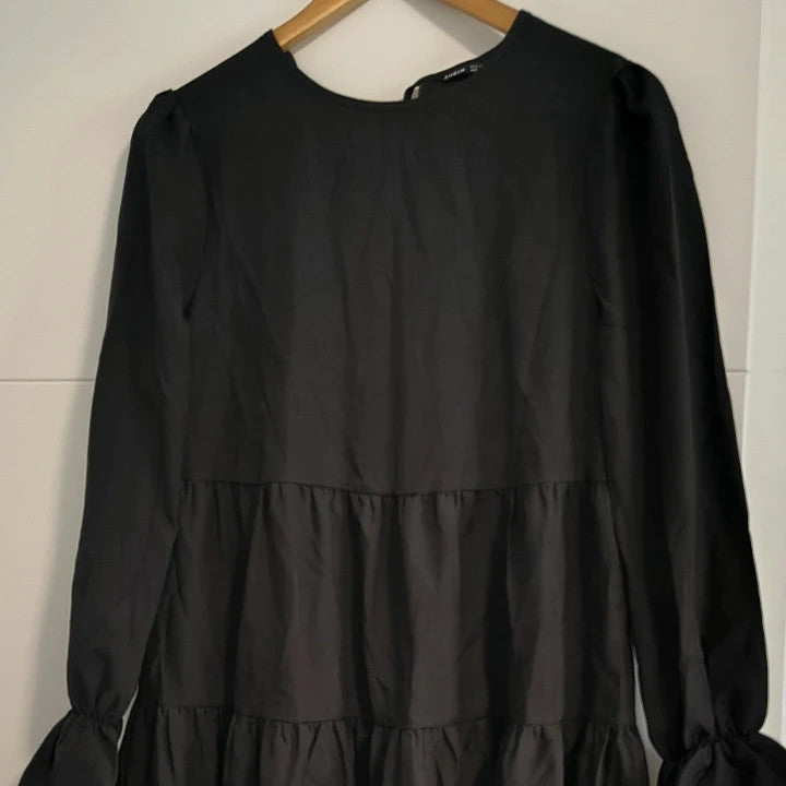 SheIn black oversized A-line dress with layered ruffle sleeves and asymmetrical hem.