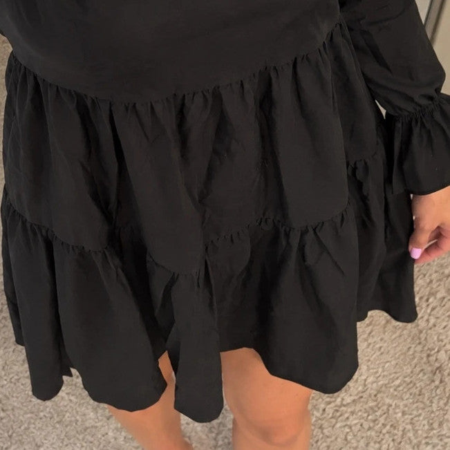 SheIn black oversized A-line dress with layered ruffle sleeves and asymmetrical hem.