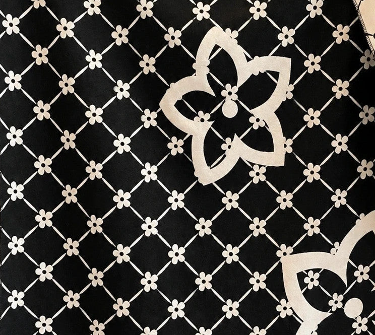 Creme shawl black cream beige floral pattern with decorative camel accents and fringes.