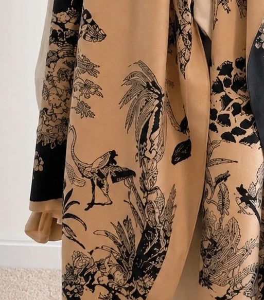 Beige shawl with black floral pattern, soft polyester material, versatile design.
