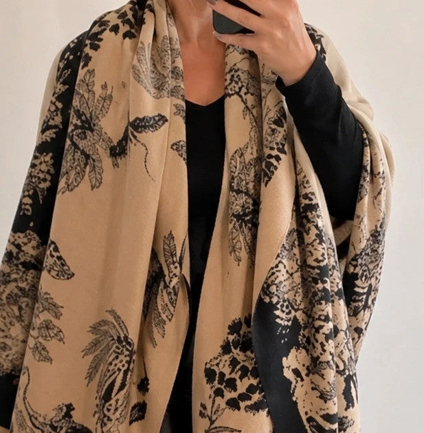 Beige shawl with black floral pattern, soft polyester material, versatile design.