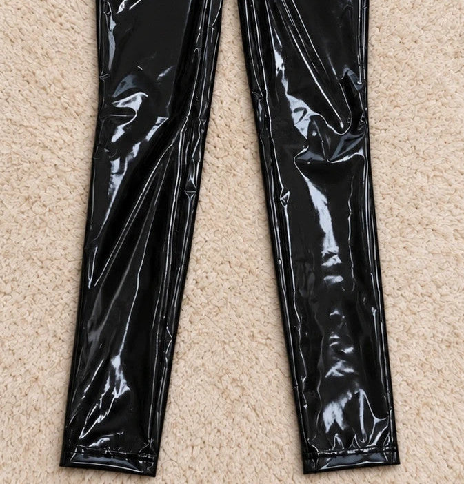 REI black jumpsuit with front zipper, fitted silhouette, and long sleeves.
