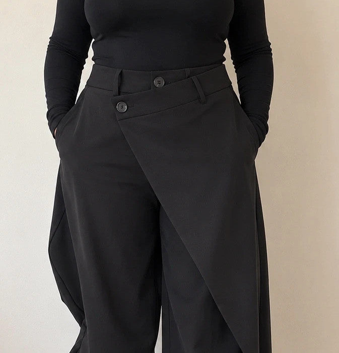 Wide leg black trousers with asymmetrical wrap design and overlapping waistband.