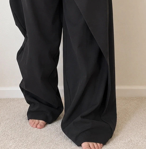 Wide leg black trousers with asymmetrical wrap design and overlapping waistband.