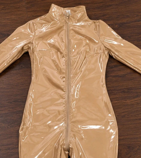 Beige jumpsuit with long sleeves, fitted silhouette, and standing collar.