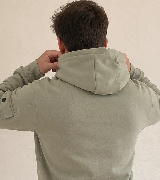 Bench green hoodie with rubber logo, kangaroo pocket, and thumbholes.